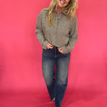 Detail of the button and zip closure and belt loops on the dark vintage wash dad jeans