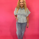 Side view showing the 31 inch inseam and ankle grazing length of the medium wash dad jeans