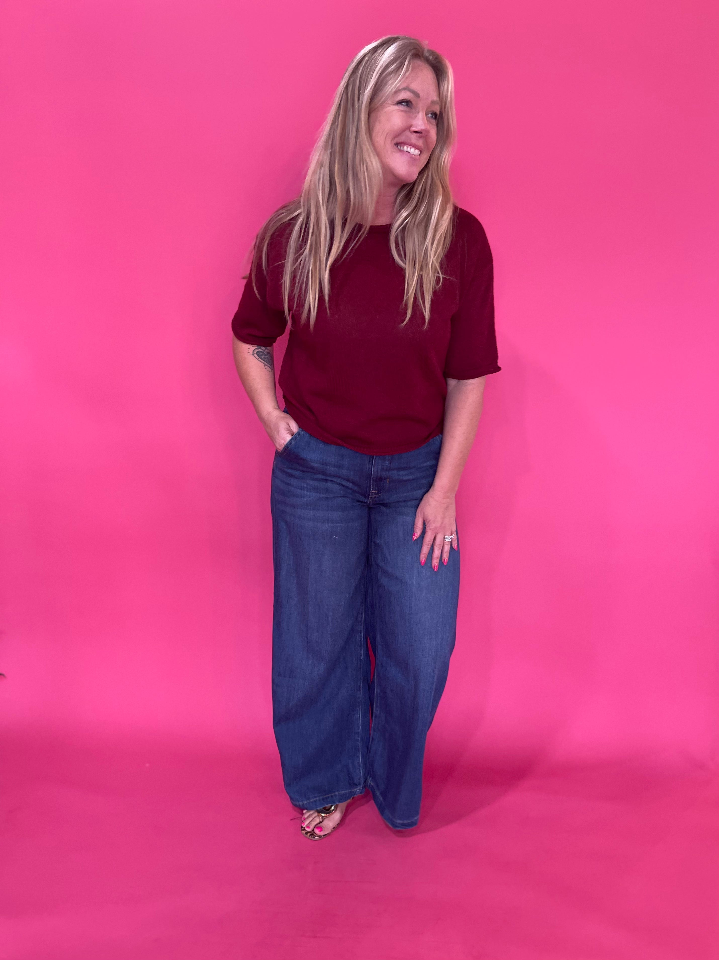 Detail of the clean non distressed hem on the dark wash wide leg jeans with a 33 inch inseam