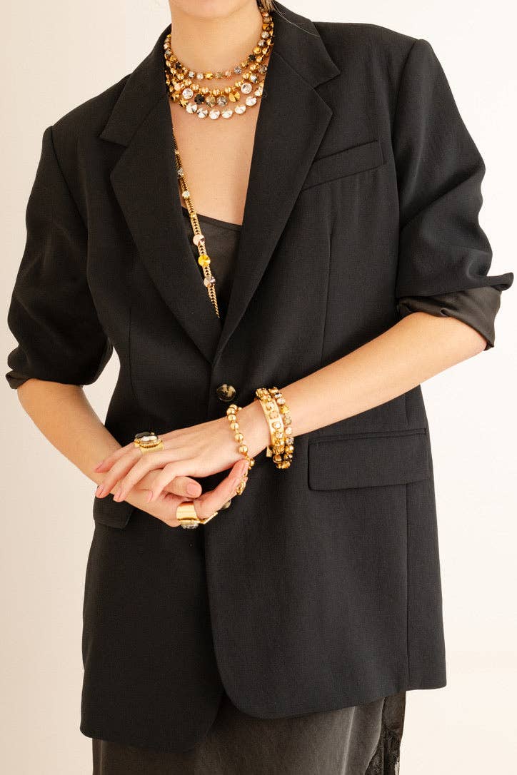 Side view showing the stretch fit of the mixed metal Izzy bracelet worn on a wrist
