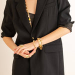 Side view showing the stretch fit of the mixed metal Izzy bracelet worn on a wrist