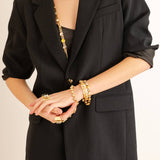 Side view showing the stretch fit of the mixed metal Izzy bracelet worn on a wrist