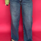 Woman wearing high rise wide leg jeans with a clean hem styled with a fitted tee tucked in