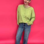 Close-up of the clean hem finish at the ankle on the high rise wide leg stretch denim jeans