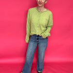 Side view showing the elongating 31 inch inseam of the high rise wide leg jeans with a clean hem
