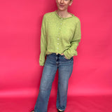 Side view showing the elongating 31 inch inseam of the high rise wide leg jeans with a clean hem