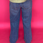Full length view of the wide leg clean hem jeans styled with heels for a night out