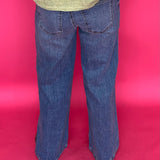 Full length view of the wide leg clean hem jeans styled with heels for a night out