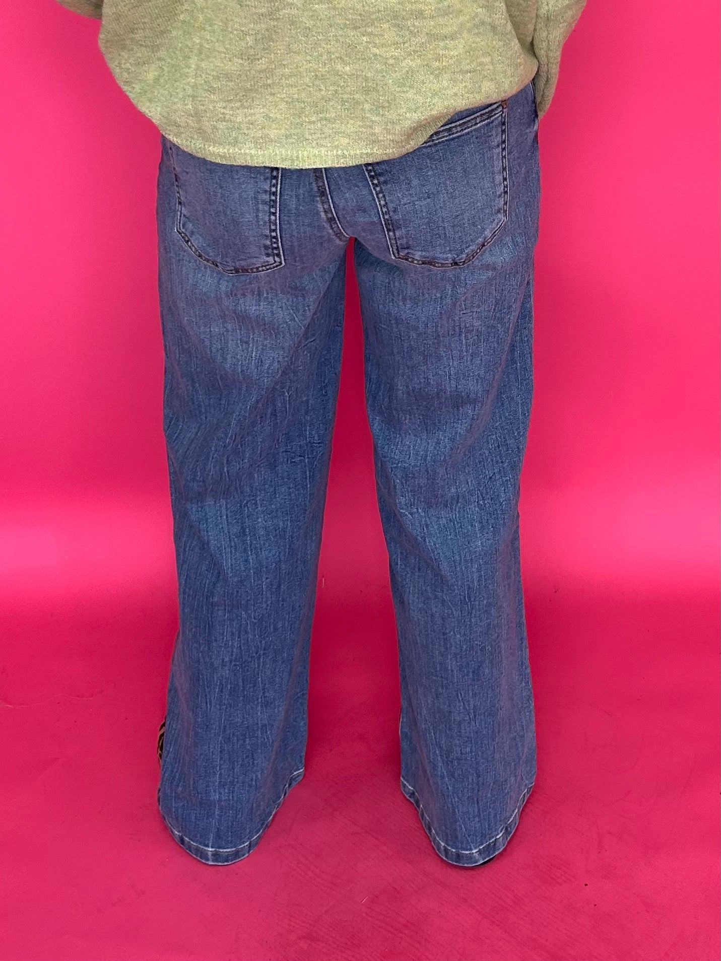 Full length view of the wide leg clean hem jeans styled with heels for a night out