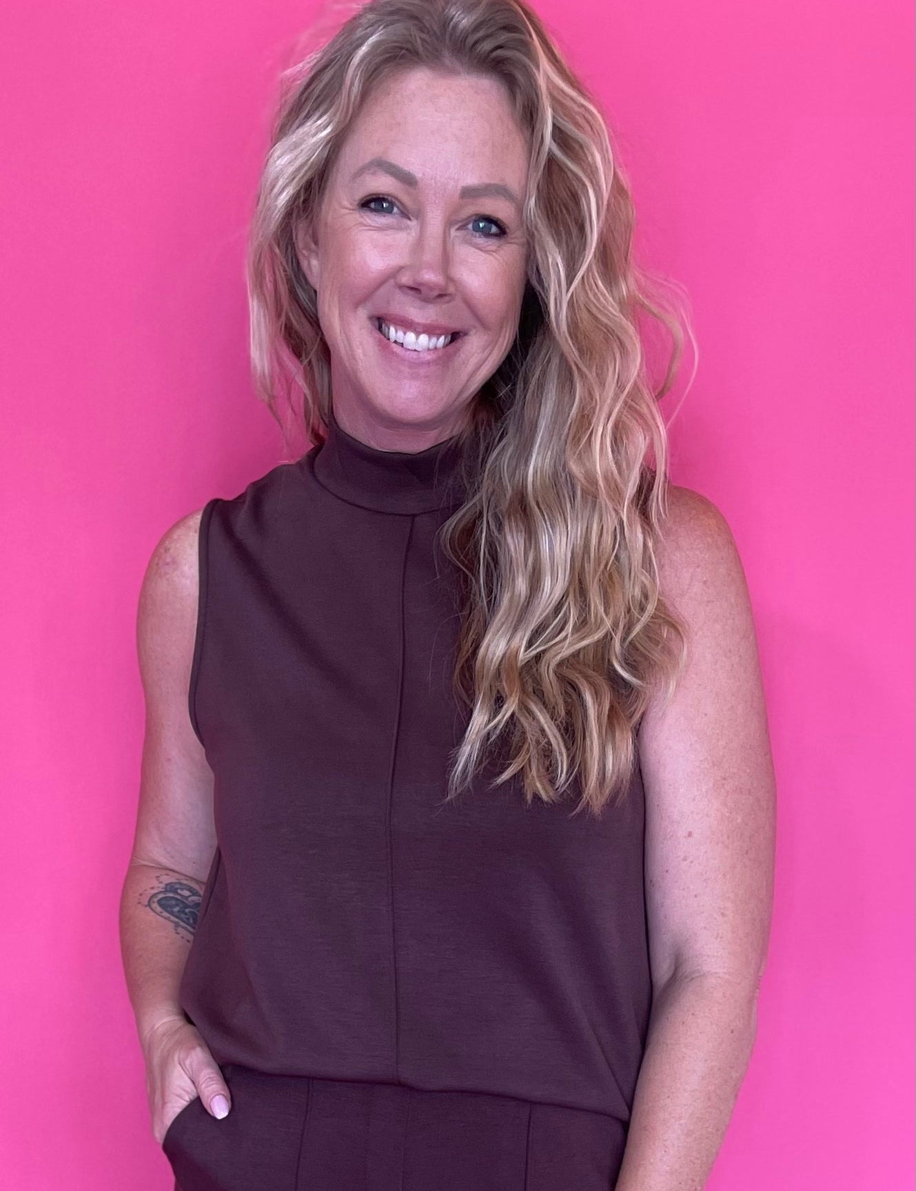 Woman wearing a warm brown everyday top tucked into denim with an easy relaxed fit