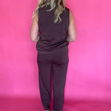 Full length view of the warm brown everyday top worn untucked with denim and sneakers