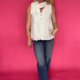 Back view of the cream sleeveless top showing the light breezy drape through the body