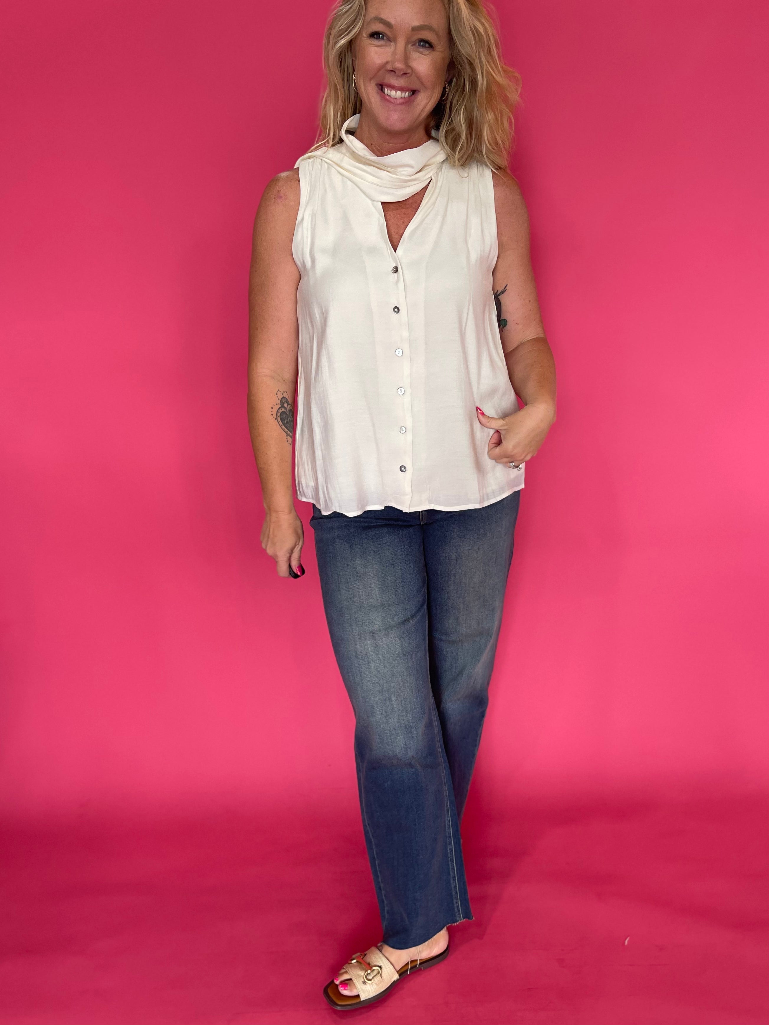 Back view of the cream sleeveless top showing the light breezy drape through the body