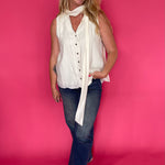 Close-up of the soft neutral cream fabric and neckline on the lightweight sleeveless top