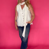 Close-up of the soft neutral cream fabric and neckline on the lightweight sleeveless top