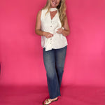 Side view of the cream top layered under an open blazer with tailored trousers for work