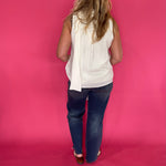 Detail of the shoulder and armhole finish on the lightweight cream sleeveless top