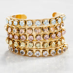 Close-up of the pink crystal setting and antique gold finish on the Kelly cuff bracelet