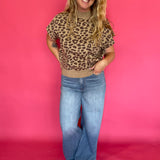 Close-up of the leopard print knit and solid ribbed hem on the cap sleeve knit top