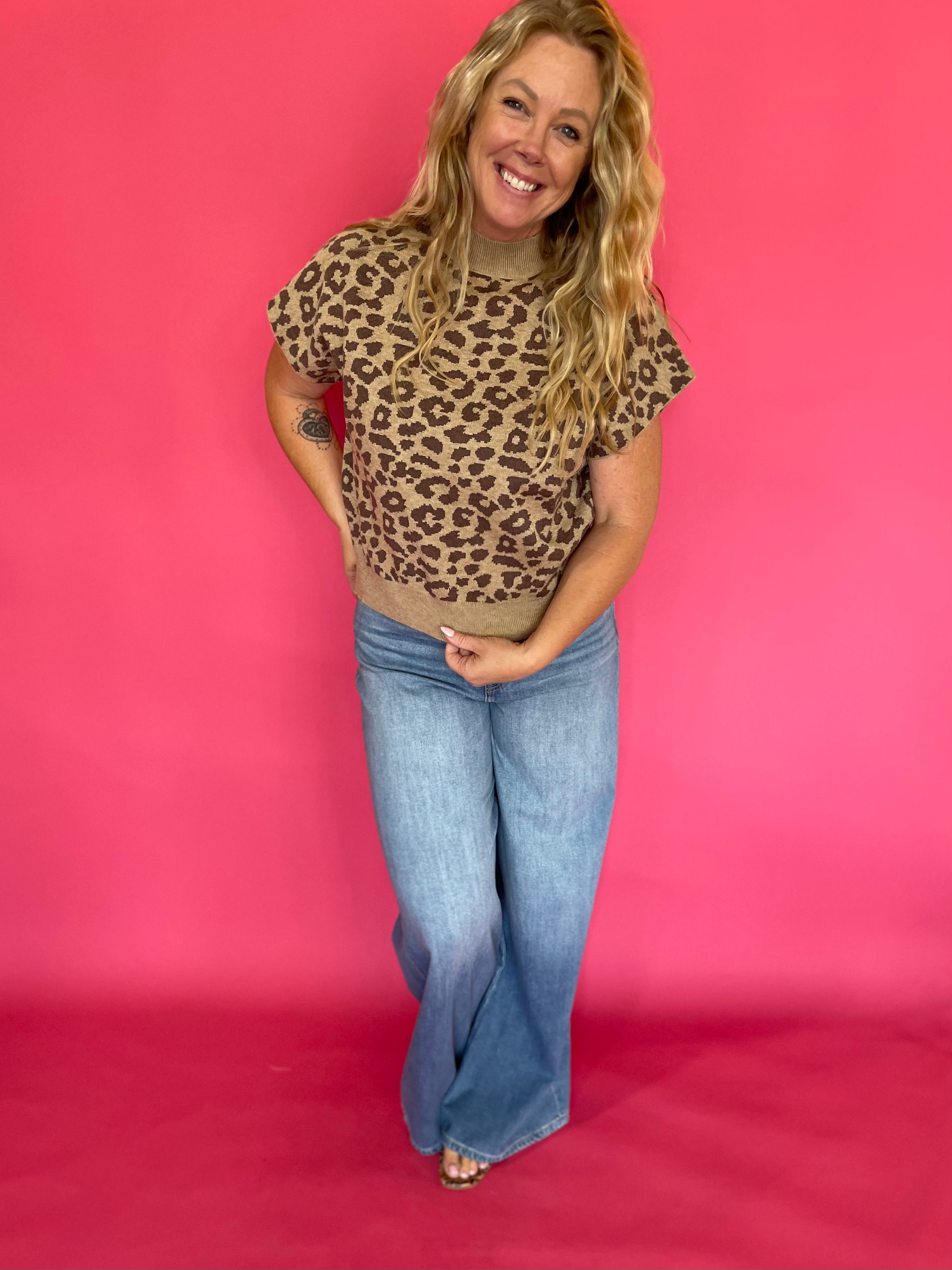 Back view of the leopard print cap sleeve knit top showing the mock neck and regular fit