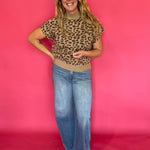 Side view of the leopard print knit top showing the extended cap sleeve shoulder coverage
