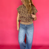 Full length view of the leopard print knit top with its mock neck and extended cap sleeves