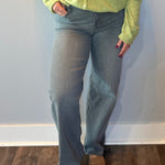 Woman wearing charcoal grey mid rise dad jeans with a relaxed straight leg and a tucked tee