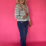 Detail of the Fab Ab front pockets smoothing the mid rise waist on the wide leg jeans