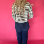 Full outfit view of the aqua striped button front cardigan styled with wide leg denim