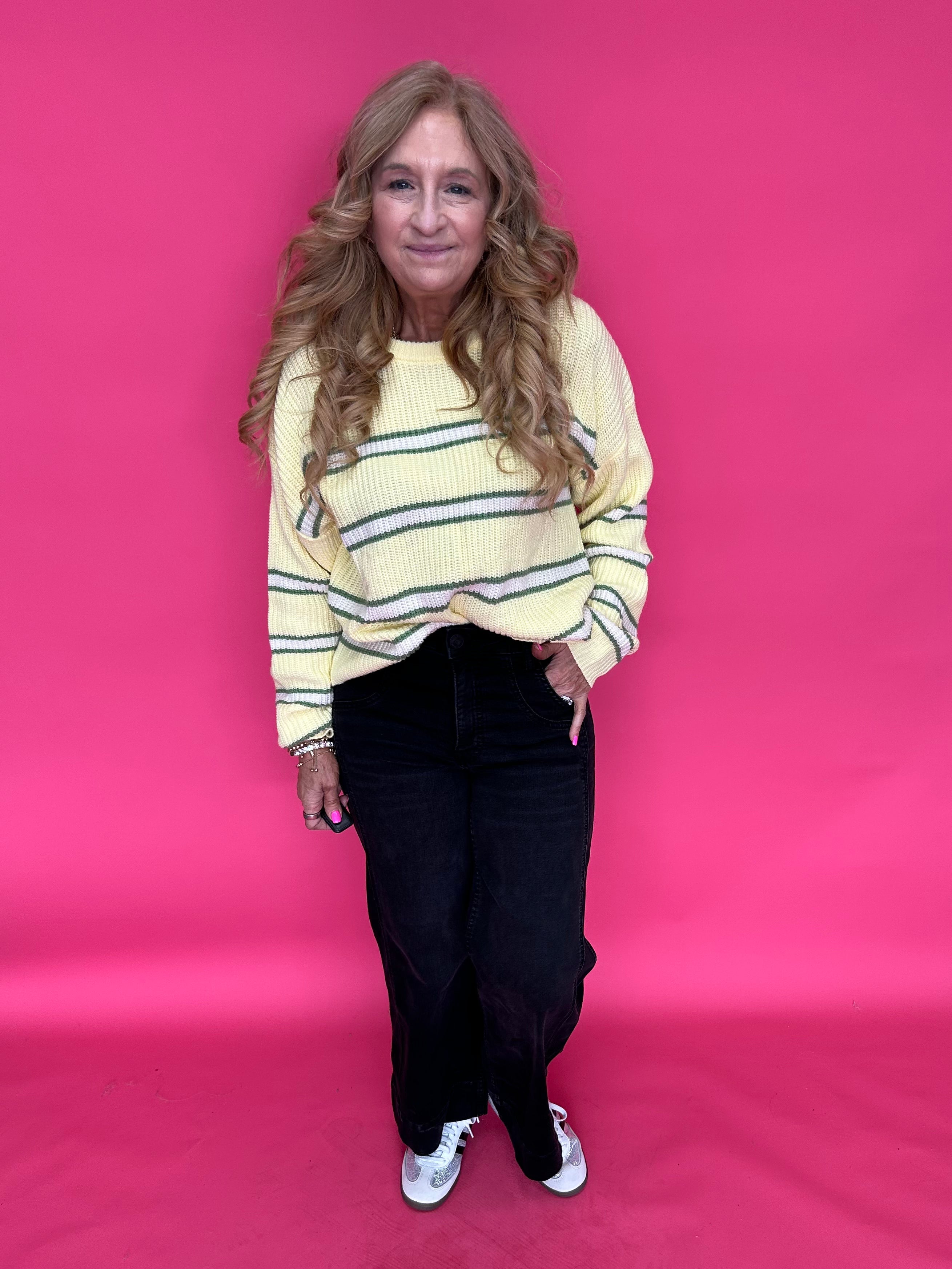 Flat lay of the black wide leg jeans showing the wide roll up hem and double front pockets