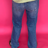 Detail of the 11 inch high rise waistband and button closure on the straight leg denim