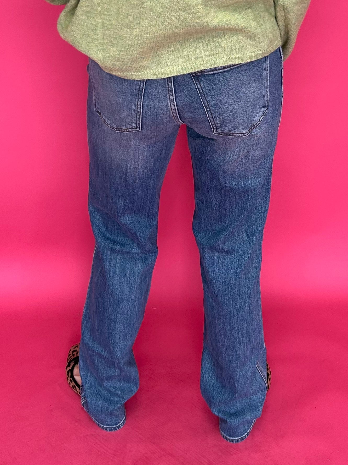 Detail of the 11 inch high rise waistband and button closure on the straight leg denim