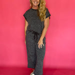 Back view of the charcoal polka dot scuba two piece set showing the relaxed cap sleeve top