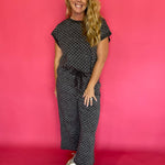 Back view of the charcoal polka dot scuba two piece set showing the relaxed cap sleeve top