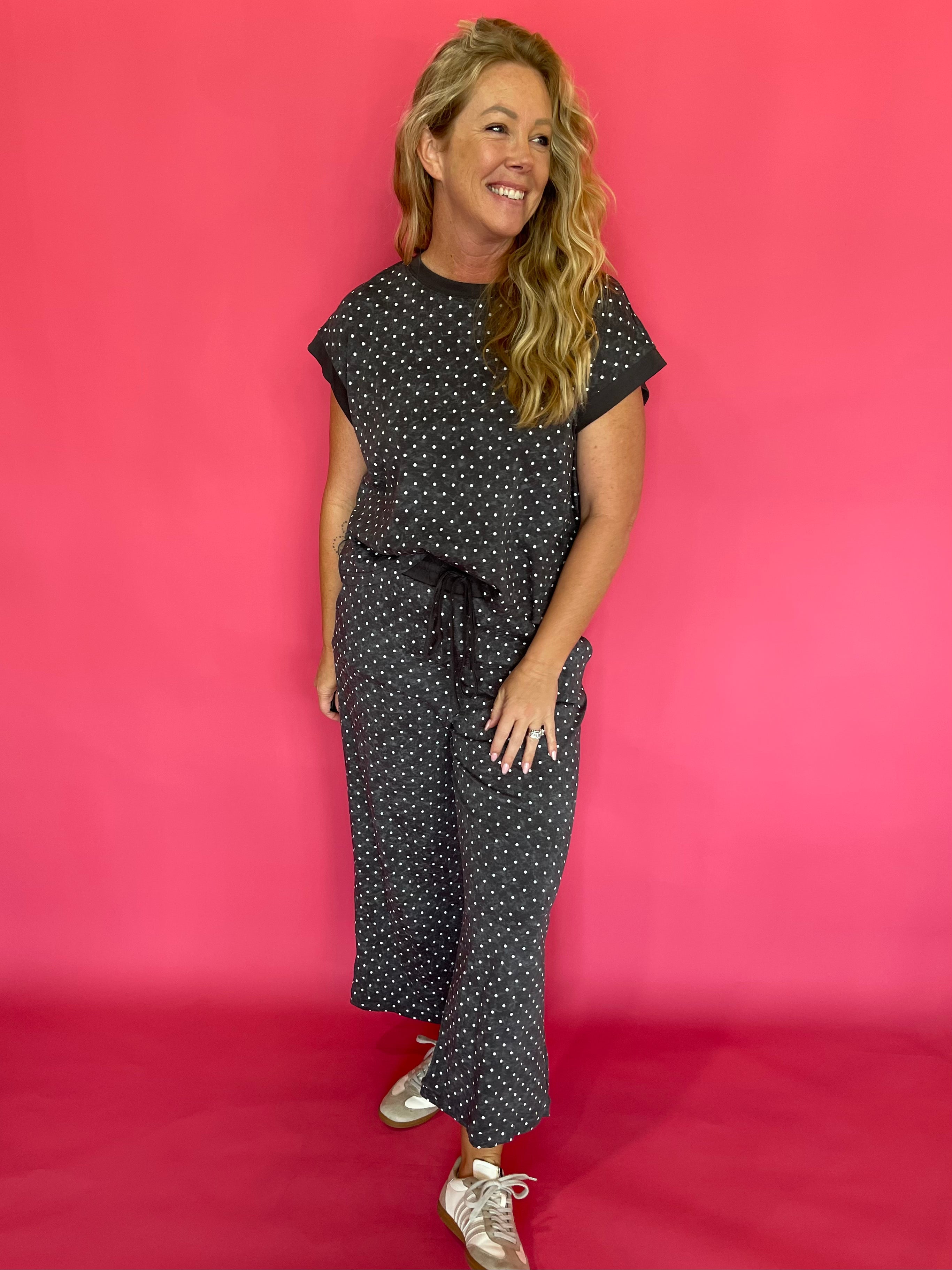 Close-up of the allover micro polka dot print on the charcoal scuba fabric lounge set
