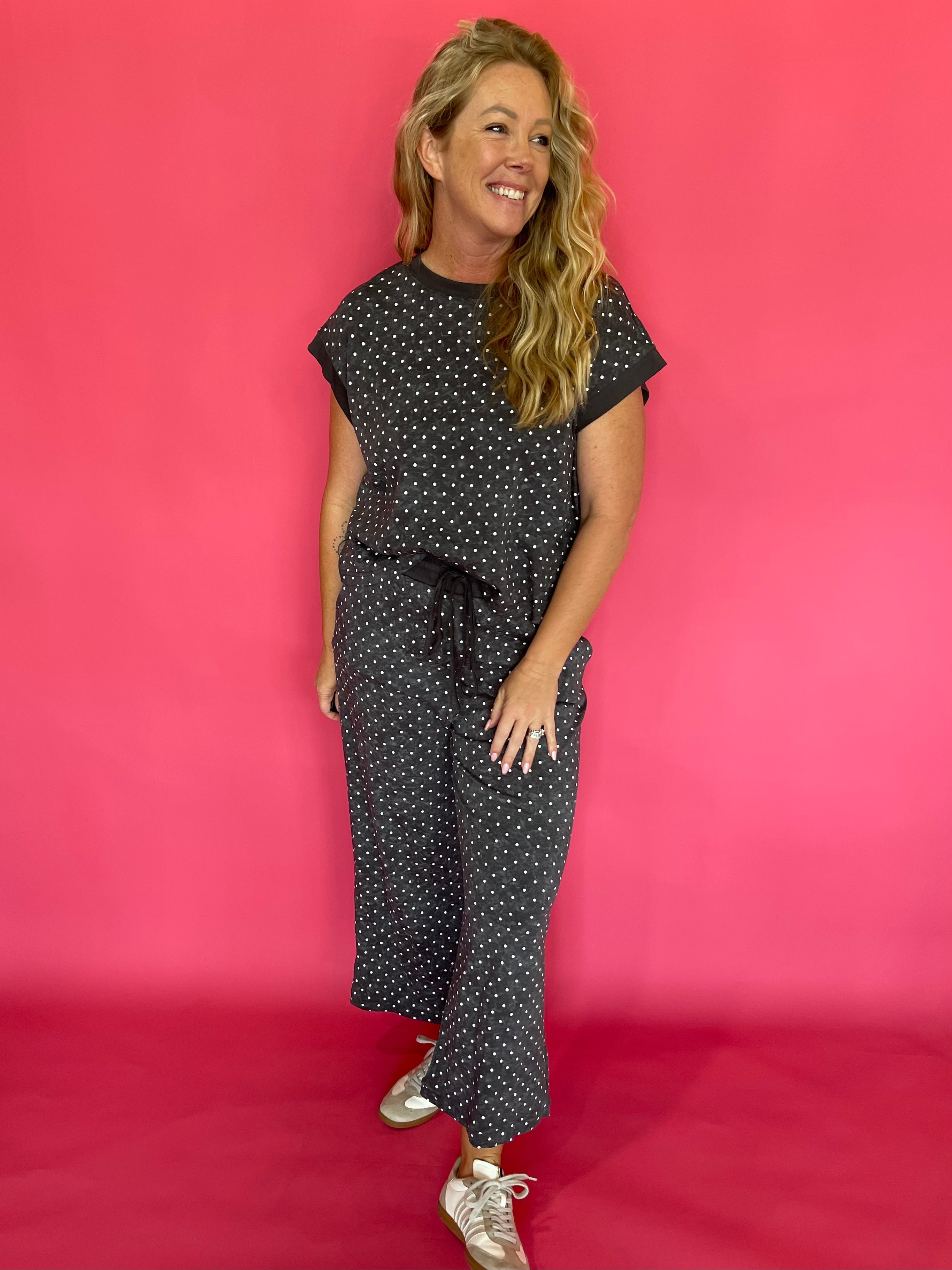 Close-up of the allover micro polka dot print on the charcoal scuba fabric lounge set