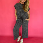 Detail of the elastic drawstring waistband on the charcoal polka dot wide leg cropped pants