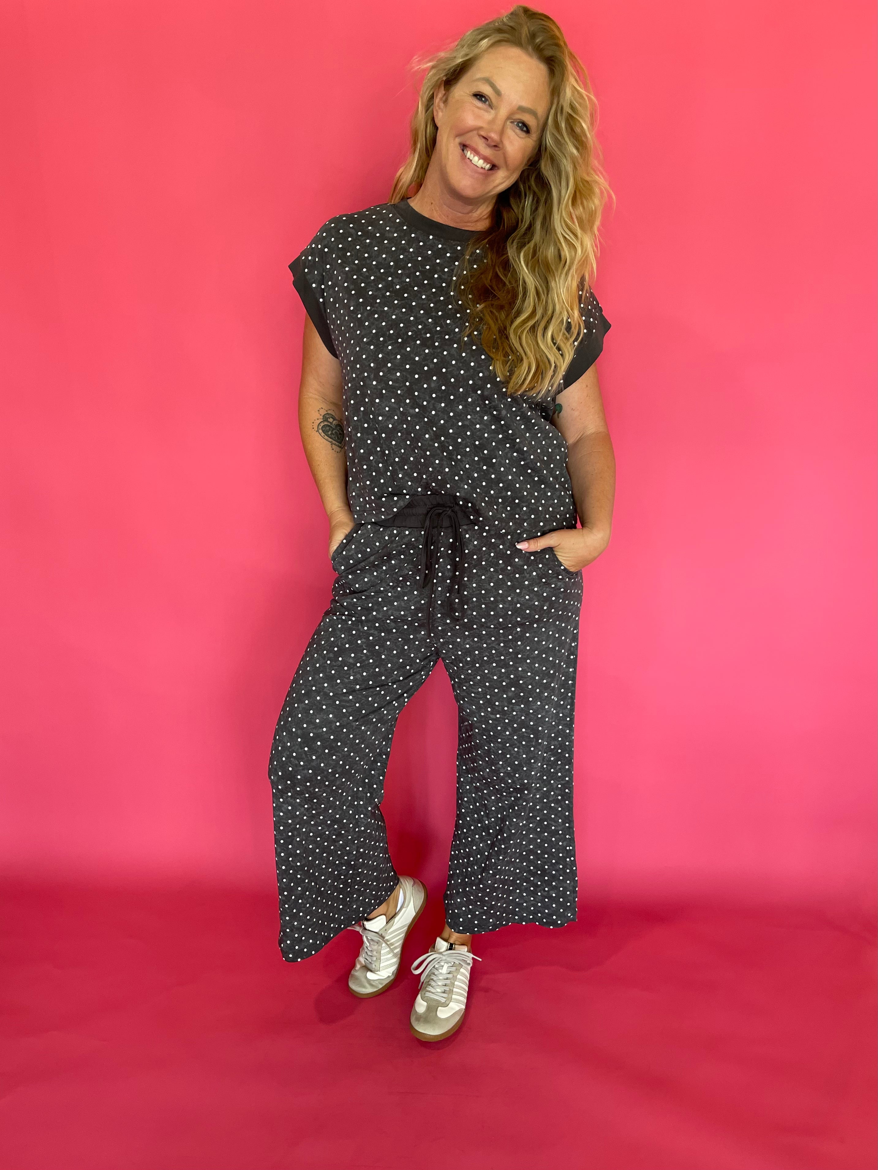 Detail of the elastic drawstring waistband on the charcoal polka dot wide leg cropped pants