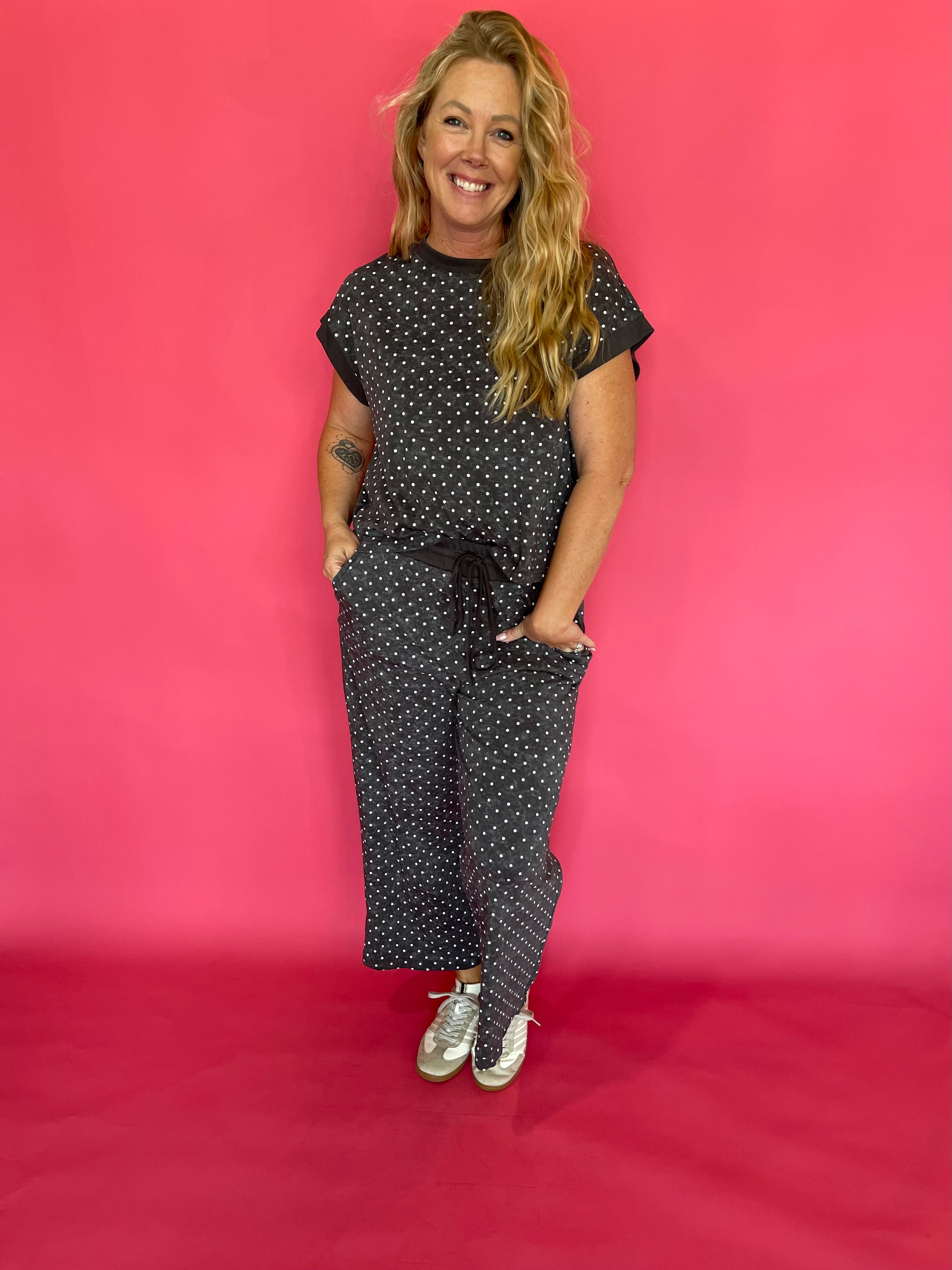 Flat lay of the charcoal micro polka dot cap sleeve top and matching wide leg cropped pants
