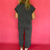 Three quarter view of the charcoal polka dot scuba set styled as an easy travel day outfit