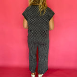Three quarter view of the charcoal polka dot scuba set styled as an easy travel day outfit
