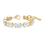 Slim antique gold bracelet set with a line of clear crystals, fastened around a model's wrist