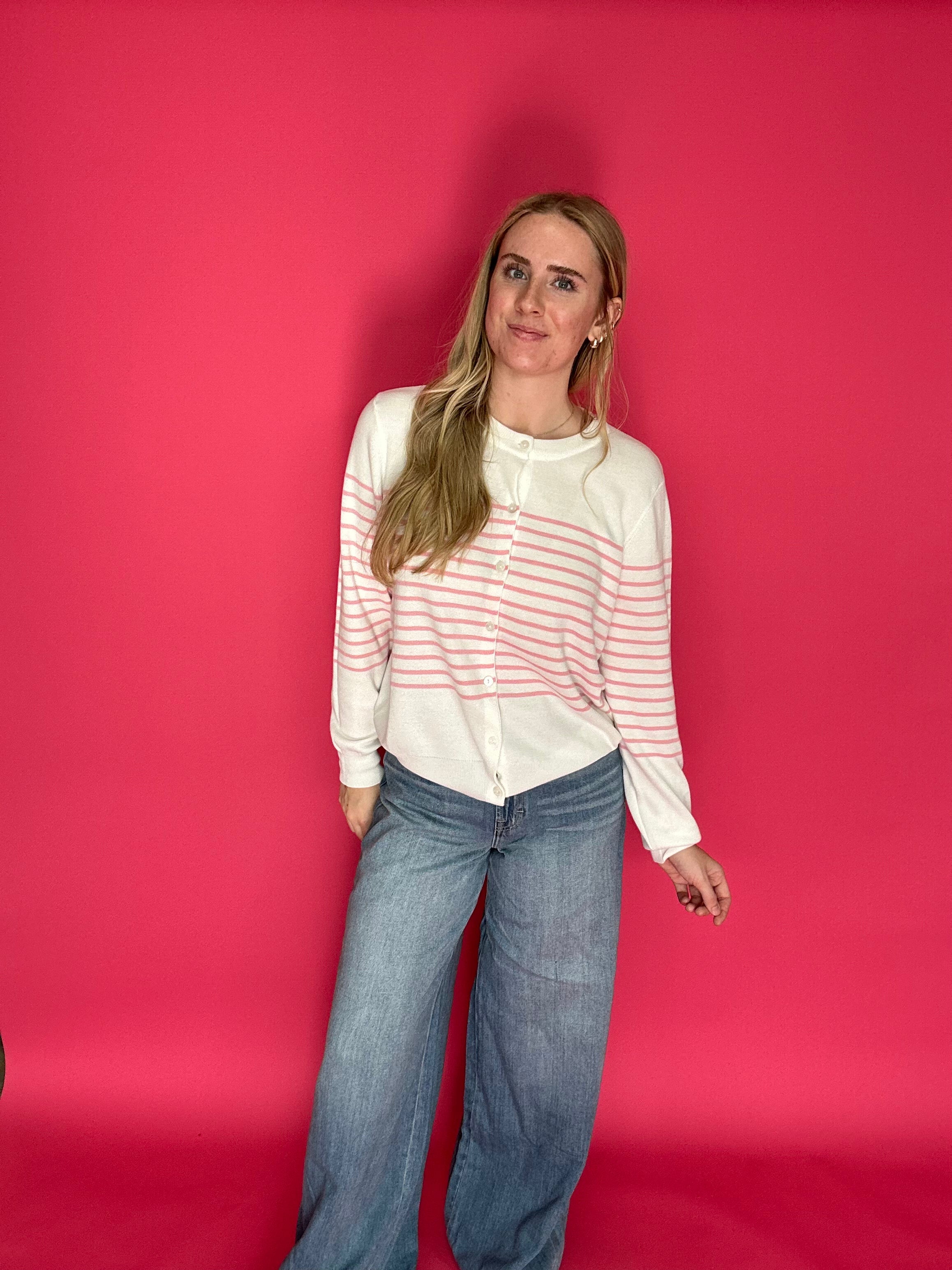 Detail of the front fly zipper and button closure at the high rise of the wide leg trouser jeans