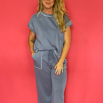Woman wearing a soft scuba matching set with a cap sleeve crew neck top and wide leg pants