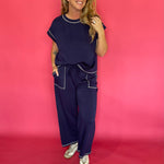 Detail of the wide leg hem and contrast stitch seam on the navy scuba lounge pants