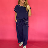 Detail of the wide leg hem and contrast stitch seam on the navy scuba lounge pants