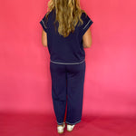 Flat lay of the navy scuba lounge top and pants laid out together as a matching set