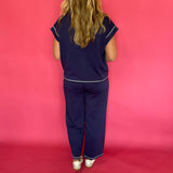 Flat lay of the navy scuba lounge top and pants laid out together as a matching set