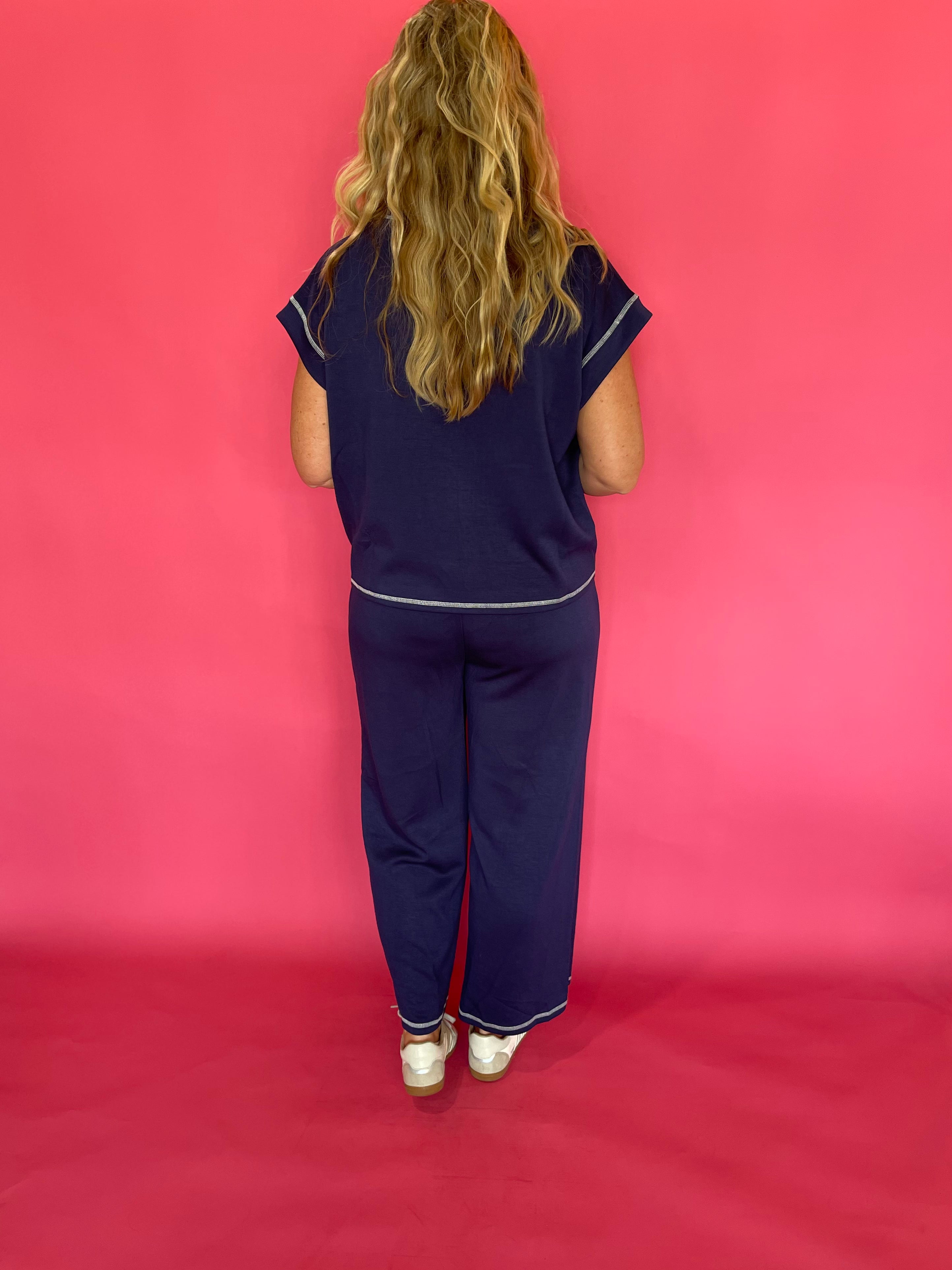 Flat lay of the navy scuba lounge top and pants laid out together as a matching set