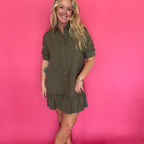 Close-up of the collar, button placket, and chest pocket on the olive shirt dress